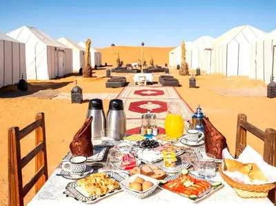 a table with food on it in the desert at merzouga asamer in Merzouga