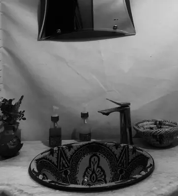 a black and white photo of a sink on a table at Azadic luxury tents in Merzouga