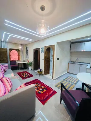a living room with a couch and a table at dar lmrrakchi in Oulad Akkou