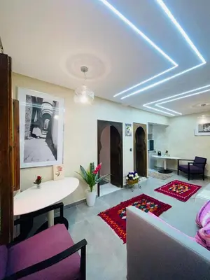 a living room with a couch and a table at dar lmrrakchi in Oulad Akkou