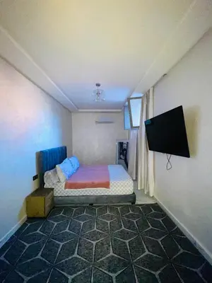 a bedroom with a bed and a flat screen tv at dar lmrrakchi in Oulad Akkou