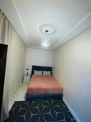 a small bedroom with a bed in a room at dar lmrrakchi in Oulad Akkou