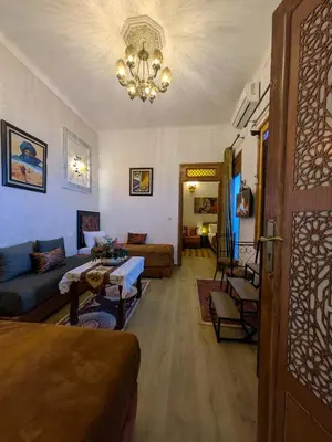 a living room with a couch and a chandelier at Apartment Amoud with a panoramic view in Fès