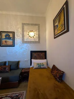 a living room with a couch and a table at Apartment Amoud with a panoramic view in Fès