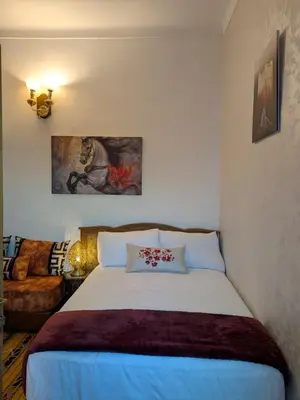 a bedroom with a bed and a couch at Apartment Amoud with a panoramic view in Fès