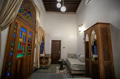 a living room with a door and a couch at Dar Borj in Fès