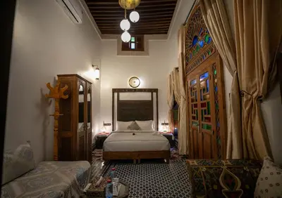a bedroom with a bed and a clock on the wall at Dar Borj in Fès