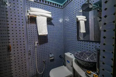 a bathroom with a blue and white tiled wall at Dar Borj in Fès