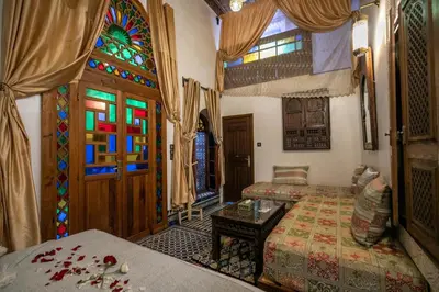 a room with a bed and a stained glass window at Dar Borj in Fès