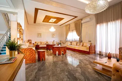 a large living room with couches and a table at Villa Perle 6 Suites with Pool 5 Min from Center in Oulad Akkou