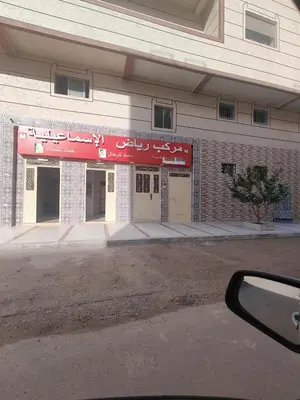 a building with a red sign on the side of it at Cozy GenYcool Apartment Meknes Center in Meknès