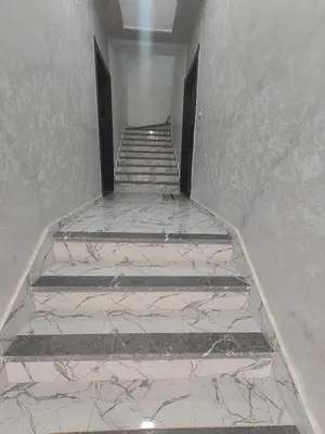 a set of stairs in a room with marble at Cozy GenYcool Apartment Meknes Center in Meknès