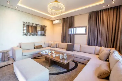 a living room with a couch and a table at Jnane Moulana Piscine Privée, Jardin & Vue Atlas