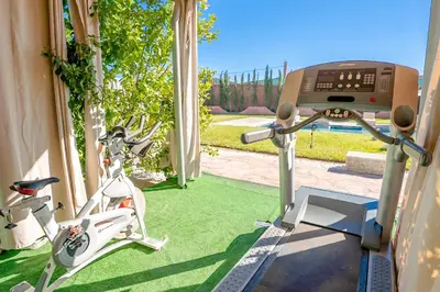 an image of a gym with two exercise bikes at Jnane Moulana Piscine Privée, Jardin & Vue Atlas