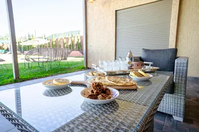 a table with food on it on a patio at Jnane Moulana Piscine Privée, Jardin & Vue Atlas