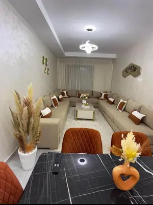 a large living room with a couch and a table at Alyassamine in Taza