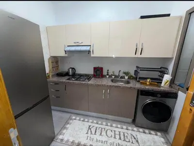 a kitchen with a sink and a washing machine at Alyassamine in Taza