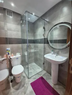 a bathroom with a shower and a toilet and a sink at Alyassamine in Taza