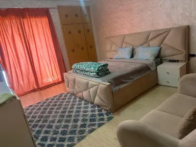 a bedroom with a bed and a couch and a chair at إقامة حسن in Fès