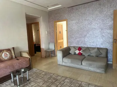 a living room with a couch and a table at إقامة حسن in Fès