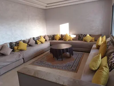 a living room with a couch and a table at إقامة حسن in Fès