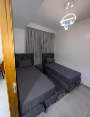 a bedroom with two beds in a room at Alyassamine Taza in Settat
