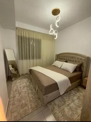 a bedroom with a bed and a chandelier at Alyassamine Taza in Settat