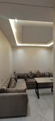 a living room with a couch and a table at Idrissi appartement in Fès
