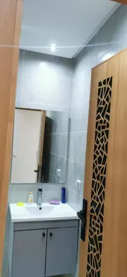 a bathroom with a sink and a mirror at Idrissi appartement in Fès