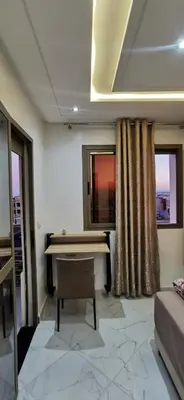 a living room with a table and a couch at Idrissi appartement in Fès