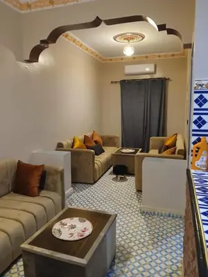 a living room with couches and a table at Casa Ayour in Merzouga