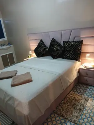 a bedroom with a large bed with pillows at Casa Ayour in Merzouga