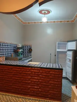 a lego kitchen with a counter top and a refrigerator at Casa Ayour in Merzouga