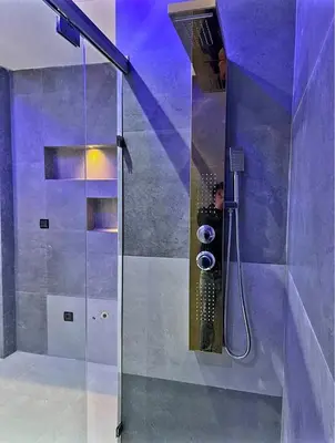a man taking a picture of a shower in a bathroom at Massira 2 in Taza