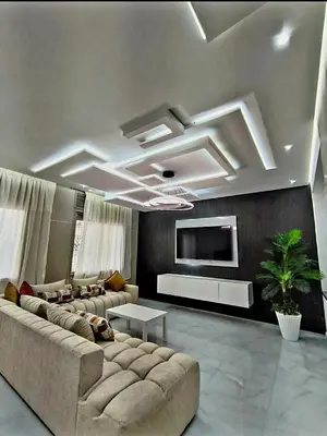 a living room with a large couch and a tv at Massira 2 in Taza