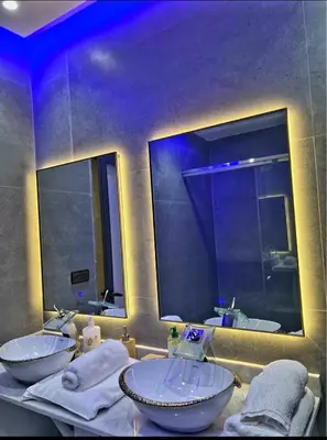 a bathroom with two sinks and a large mirror at Massira 2 in Taza