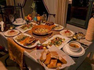 a table with plates of food on a table at Sahara Luxury Camp in Merzouga