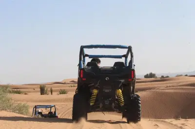 a person driving a four wheeler in the desert at Maria'S Luxury Camp in Merzouga