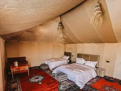 a bedroom with two beds in a tent at Maria'S Luxury Camp in Merzouga