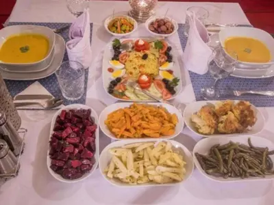 a table topped with plates of food and bowls of food at Dream Land Camp in Merzouga