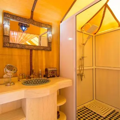 a bathroom with a sink and a shower at Dream Land Camp in Merzouga