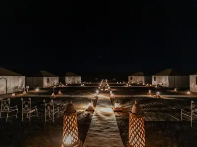 a row of lights on a road at night at Dream Land Camp in Merzouga