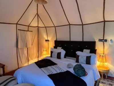 a bedroom with two beds in a tent at Dream Land Camp in Merzouga
