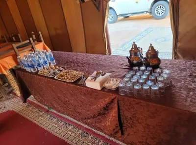a table with food and drinks on top of it at Chebbi Desert Camp in Merzouga