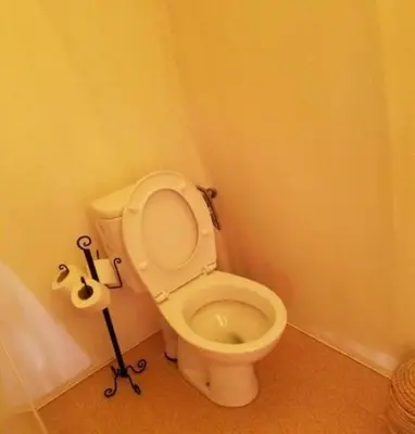 a bathroom with a white toilet in a room at Chebbi Desert Camp in Merzouga
