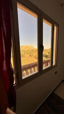 a window in a room with a view of a field at Apartment with Pool & Kasbah View in Aït Ben Haddou