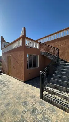 a building with a staircase in front of it at Apartment with Pool & Kasbah View in Aït Ben Haddou