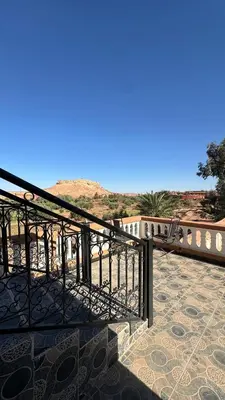 a balcony with a railing with a view of the desert at Apartment with Pool & Kasbah View in Aït Ben Haddou