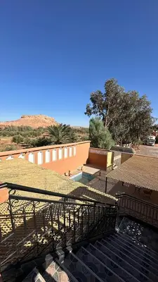 a view of a building with a roof and stairs at Apartment with Pool & Kasbah View in Aït Ben Haddou