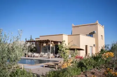a building with a swimming pool in front of a house at Luxury VILLA - Pool-view Atlas-Ourika-Golfs in Akkara
